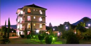 a large building with its lights on at night at Greenhome apartment in Poli