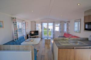 a kitchen and living room of a caravan at Sirocco Caravan in Westward Ho