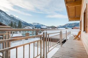 a balcony with a view of the snow covered mountains at Highalp Apartments in Tannheim