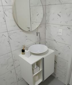 a white bathroom with a sink and a mirror at Coloft - Hospedagem e Coworking in Anápolis +28 photos