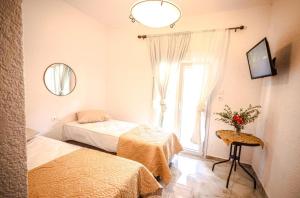 a bedroom with two beds and a window at Villa Theano 2 in Toroni