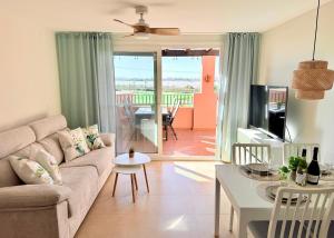 a living room with a couch and a table at Calma Suite Apartment - Mar Menor Golf Resort in Torre-Pacheco