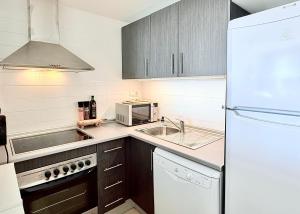 a kitchen with a white refrigerator and a sink at Calma Suite Apartment - Mar Menor Golf Resort in Torre-Pacheco +16 photos