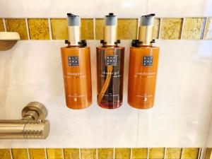 a group of three shampoo bottles on a counter at Boutique Hotel am Bodensee in Friedrichshafen