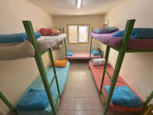 a room with four bunk beds in it at The Shelter Hostel Eilat in Eilat
