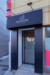a building with a black awning over a door at Wayhome Gasan in Seoul