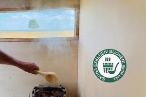 a person holding a wooden spoon next to a sign at Sleep Space 23 - Green Tiny Spot Schillig in Wangerland +21 photos