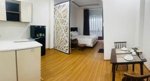 a kitchen and a living room with a table and a room at Full House Hotel Apartment in Danang