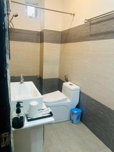 a bathroom with a white toilet and a sink at Full House Hotel Apartment in Danang +24 photos
