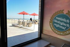 a window of a restaurant with a view of the beach at Sleep Space 24 - Green Tiny Spot Schillig in Wangerland
