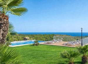 a swimming pool with a view of the ocean at Ca na Moli in Artá