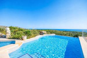 a swimming pool with a view of the ocean at Ca na Moli in Artá
