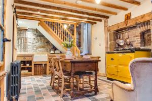 a kitchen with a wooden table and a yellow cabinet at The Cow House - In the heart of Whitby in Whitby +16 photos