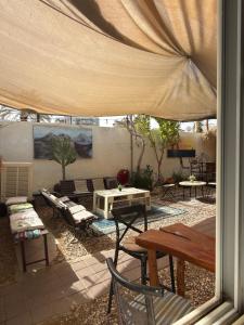 a patio with a table and chairs and a tent at The Shelter Hostel Eilat in Eilat