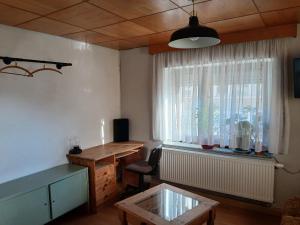a living room with a table and a window at Ferienzimmer Muns in Annaberg-Buchholz