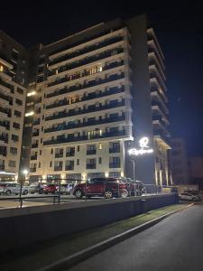 a car parked in front of a large building at night at Cozy space in Iaşi