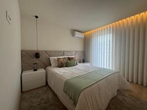 a bedroom with a large bed and a window at Apulia Seawind in Apúlia +30 photos