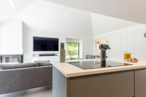 a kitchen and living room with a couch at The Studio at Cherry Tree in Natland