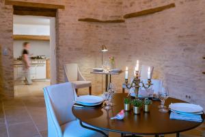 a dining room with a wooden table and blue chairs at Clos Saint Jacques - Maison d'Hôtes in Meursault
