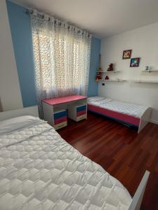 a bedroom with two twin beds and a window at Sea View Apartment in Durrës +15 photos
