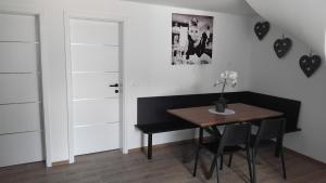 a dining room with a table and a door at Vila Azzuro in Žusterna