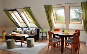 a living room with a couch and a table at Brauer Panzió in Mecseknádasd