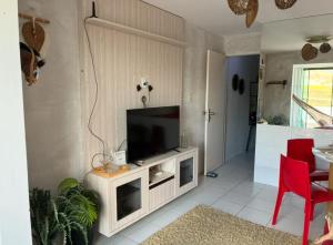 a living room with a flat screen tv on a cabinet at Flat em Gravatá in Gravatá