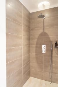 a bathroom with a shower with a glass door at La Balade des Marais in Saint-Molf +46 photos