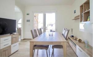 a dining room with a wooden table and chairs at Ca' Luci in Marina San Gregorio