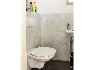 a bathroom with a toilet and a sink at Christoffellaan 101 in Brouwershaven +14 photos