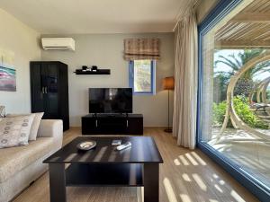 a living room with a couch and a table at Villa Odysseus Spartia Kefalonia in Spartià