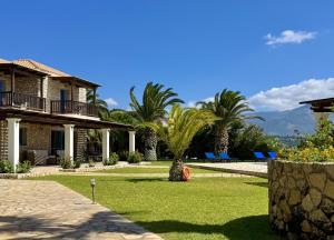 a house with a palm tree in the yard at Villa Odysseus Spartia Kefalonia in Spartià