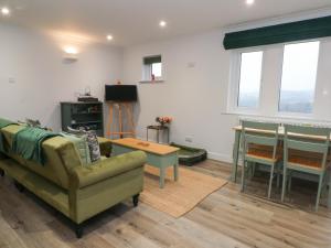 a living room with a couch and a table at Moorview in Holmfirth
