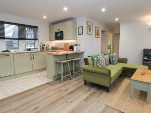 a kitchen and living room with a couch and a table at Moorview in Holmfirth