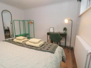 a bedroom with a bed with a desk and a chair at Moorview in Holmfirth