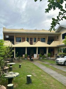 a building with a car parked in front of it at Laguno Hostel and Guest House in Moalboal