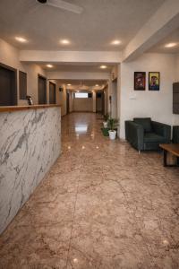 a lobby with a marble counter and a couch at Hotel Blueberry Bhedaghat in Jabalpur