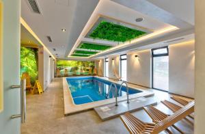 a swimming pool in a house with a ceiling at Zlatibor Pine & Peak in Zlatibor
