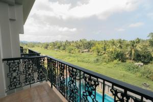 a balcony with a view of the jungle at Seashell Samssara Havelock in Havelock Island