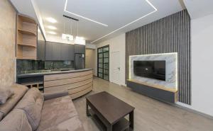 a living room with a couch and a fireplace at Zvartnots International Hotel in Pʼarakʼar