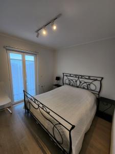 a bedroom with a large bed with a metal frame at The Lakeview Cottage near Shiroka center in Shirokë