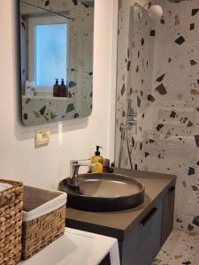 a bathroom with a sink and a mirror at The Lakeview Cottage near Shiroka center in Shirokë +13 photos