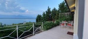 a balcony of a house with a view of the water at The Lakeview Cottage near Shiroka center in Shirokë