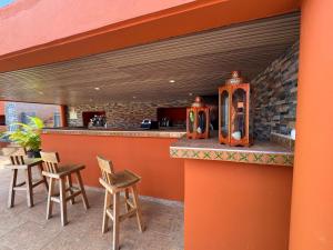 an outdoor bar with two chairs and a counter at Le Passamainty Lodge in Mamoudzou