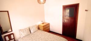 a bedroom with a bed and a dresser and a mirror at Gulbenkian 39 in Vila Nova de Gaia +36 photos