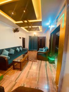 a living room with a couch and a tv at Blue mount stay in Gūdalūr