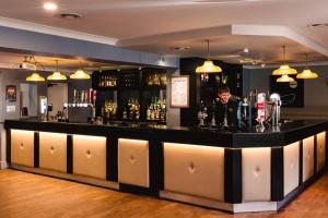 a bar with a man standing behind the counter at Crown Lodge Hotel in Wisbech +64 photos