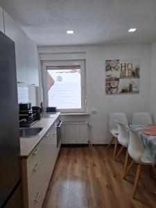 a kitchen with a table and chairs and a window at Ferienhaus Werratalsee in Frieda +20 photos