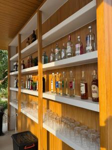 a room with shelves filled with alcohol glasses at Zana Villas in Krabi