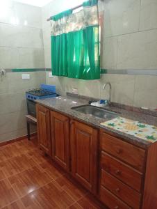 a kitchen with a sink and a stove at Cabañas los Materos 3 in Santa María